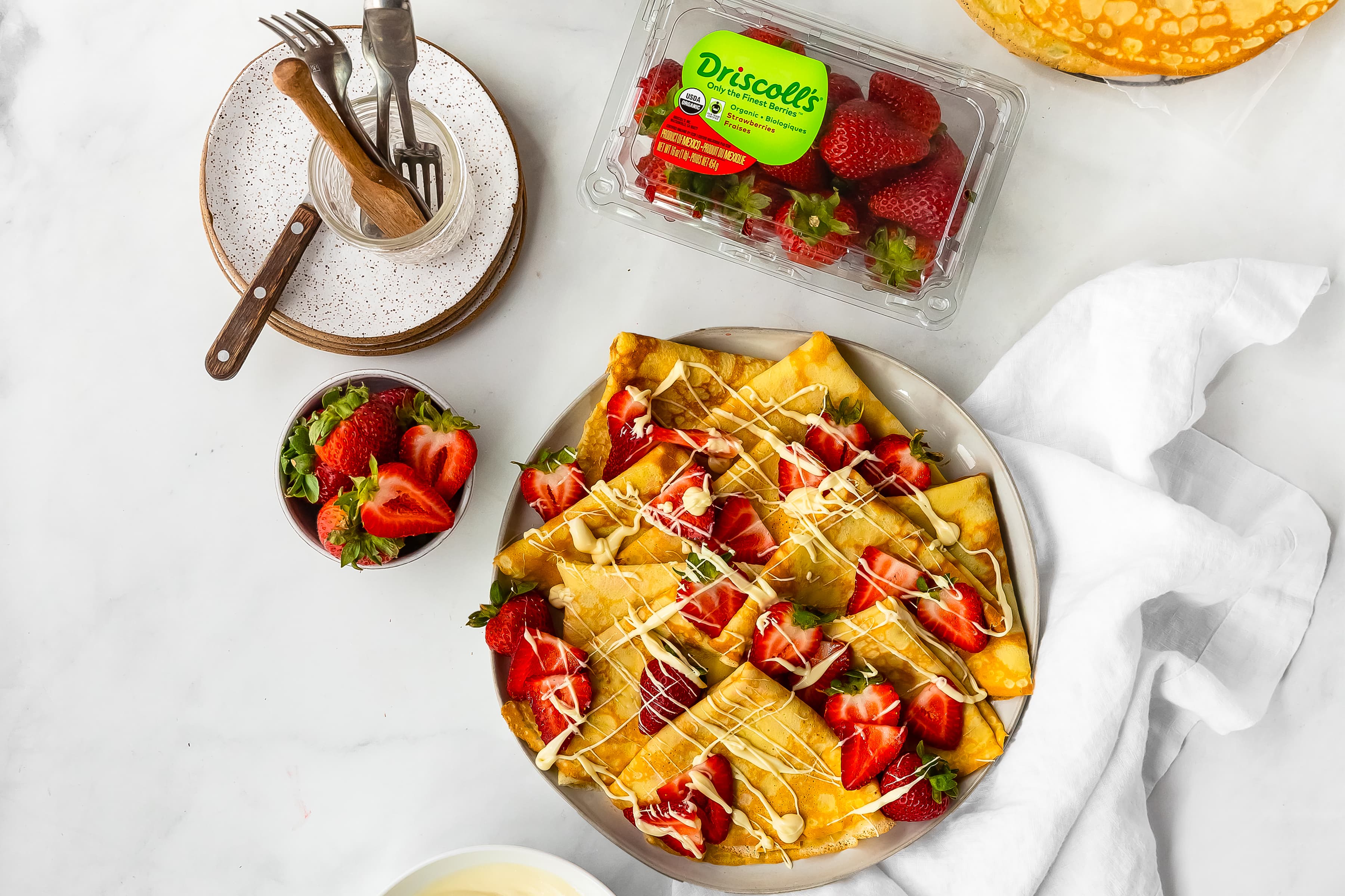 Driscoll's strawberry crepes with white chocolate drizzle