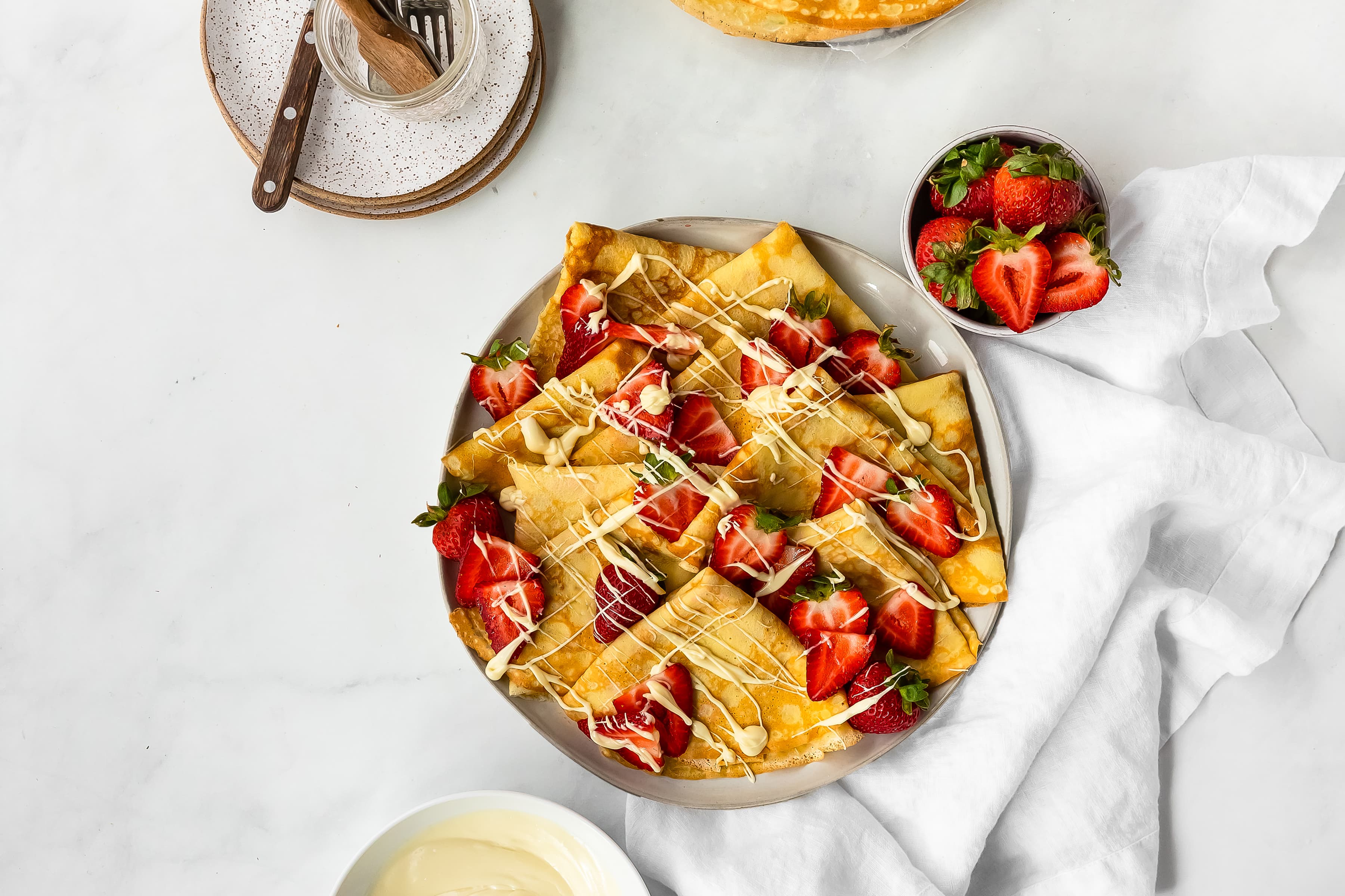 Driscoll's strawberry crepes with white chocolate drizzle