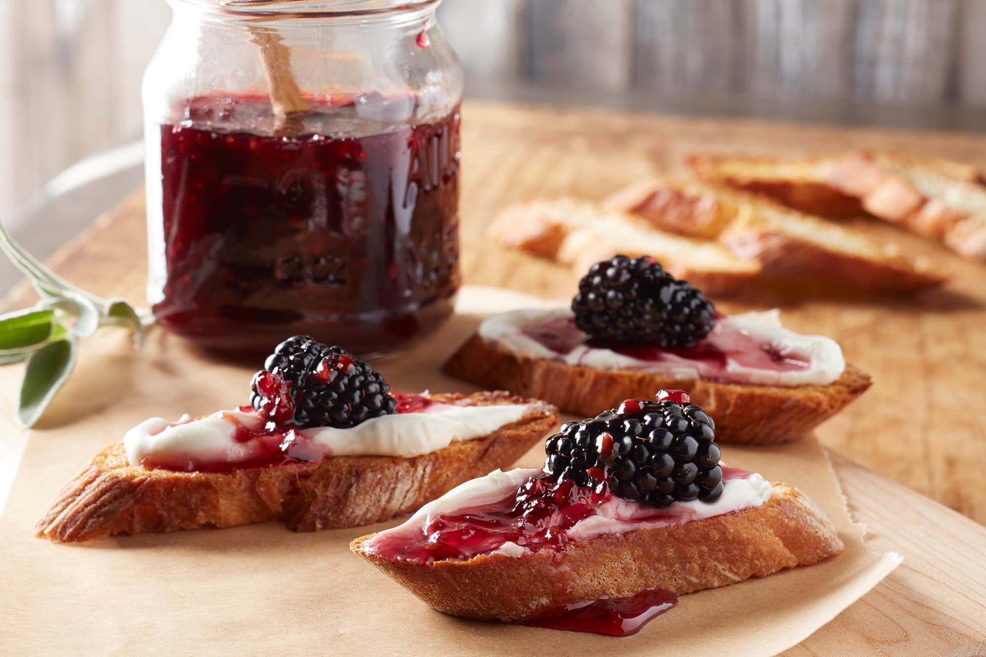 Toast with blackberry jam and a blackberry on top