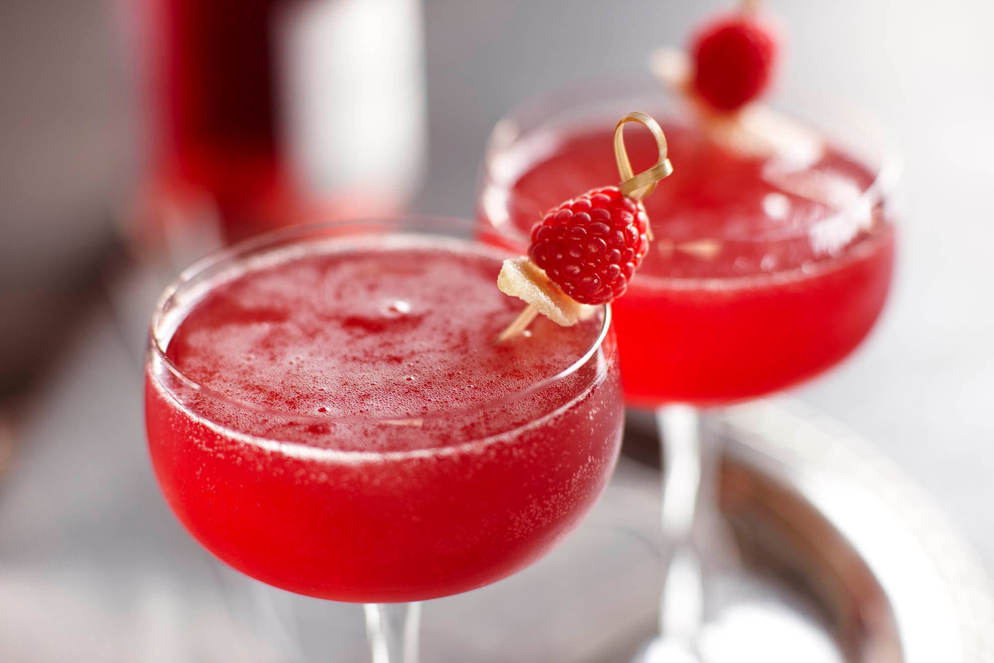 Two glasses of raspberry ginger bellinis