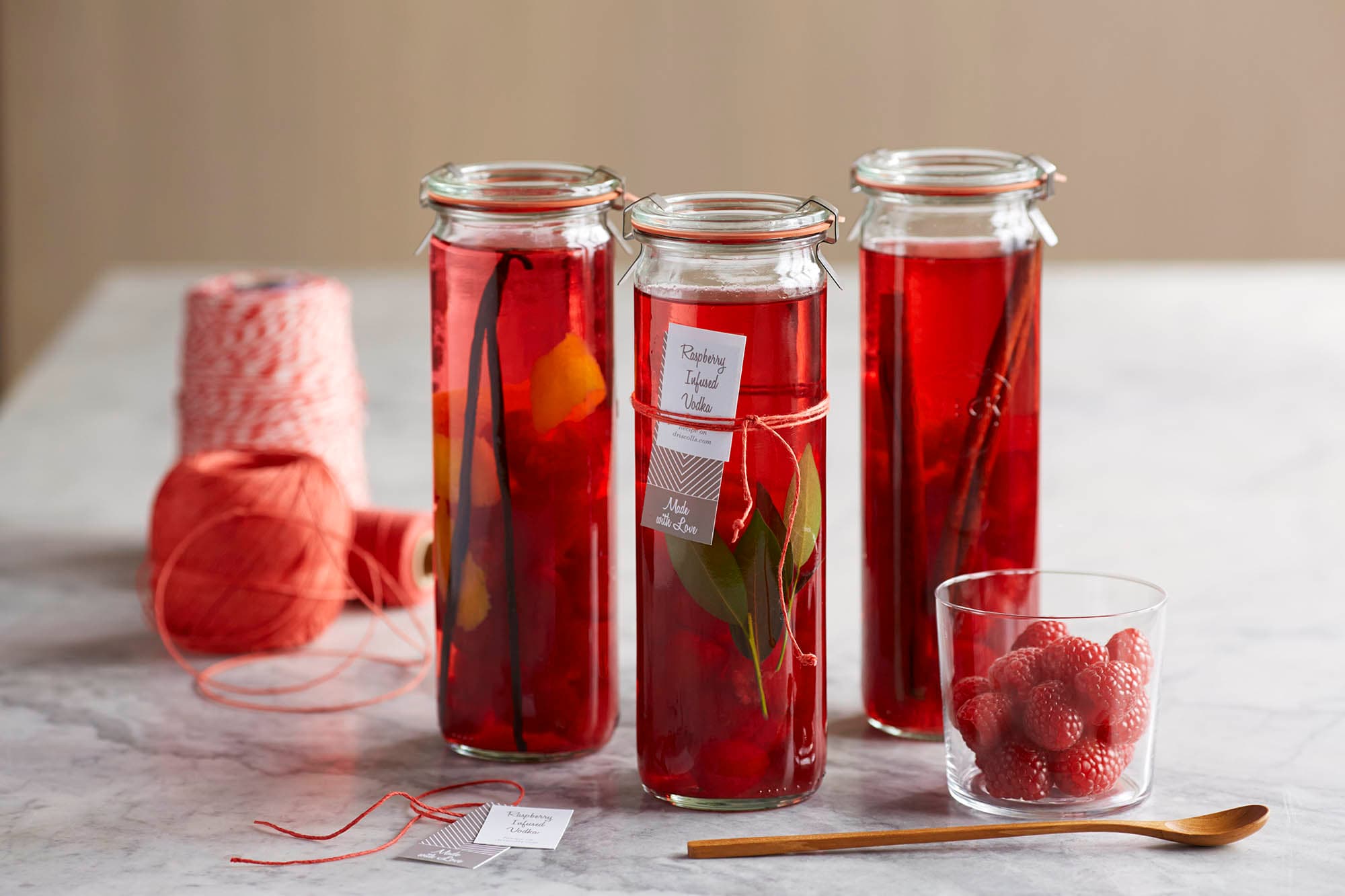 Three jars of raspberry infused vodka
